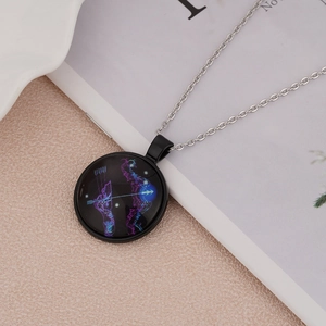 Macro shot of luminous Sagittarius zodiac pendant with black frame on a minimalist background