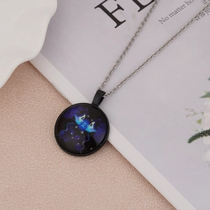 Macro detail of silver Gemini constellation necklace with luminous blue-purple glass pendant
