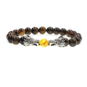 Tiger eye stone bracelet with dual silver dragon heads and a yellow bead on white background
