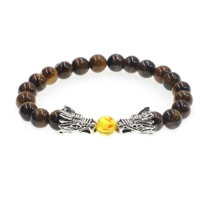 Tiger eye stone bracelet with two silver dragon heads and yellow bead on white background