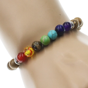 Seven chakra stone bracelet with wooden beads and silver spacers on a model wrist
