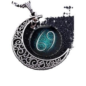 Vintage silver crescent moon necklace with Cancer zodiac sign glass pendant on white background