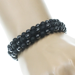 Three-row woven bracelet with black lava stones and silver beads on a wrist