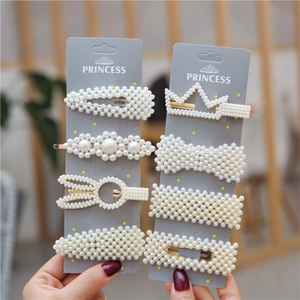 Elegant seven-piece pearl hair clip set with gold metal finish and various stylish shapes