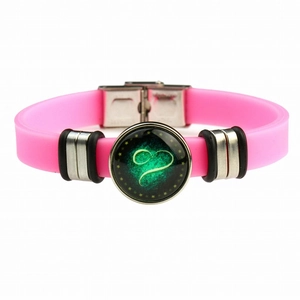 Close-up of pink silicone zodiac bracelet with stainless steel clasp and heart charm