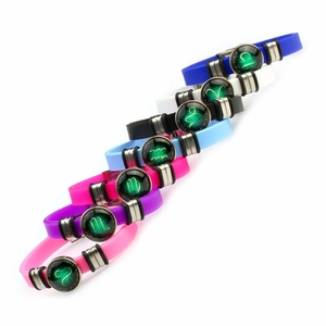 Detail view of multicolored silicone zodiac bracelets with luminous glass pendants