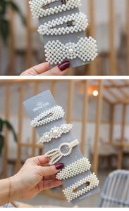 Detail view of pearl hair clip set featuring bow and geometric shapes on display card