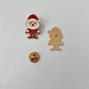 Detailed back view of a red Santa enamel pin showing textured metal and gold butterfly clutch