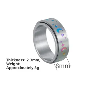 Detail view of 8mm wide rotating spinner ring with colorful moon and star patterns