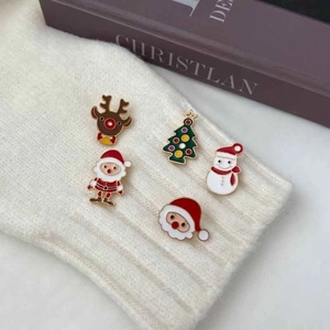 5-piece set of Christmas enamel pins featuring Santa, reindeer and tree on knit fabric
