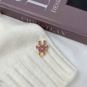Cute Christmas reindeer brooch pin with brown enamel and gold accents on knit sweater