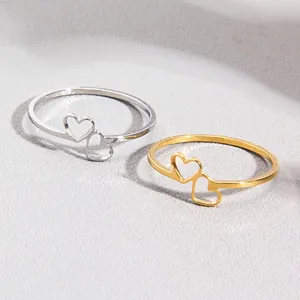 Minimalist stainless steel double heart rings set in polished gold and silver finishes