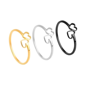 Three minimalist stainless steel rings with hollow heart design in gold, silver and black