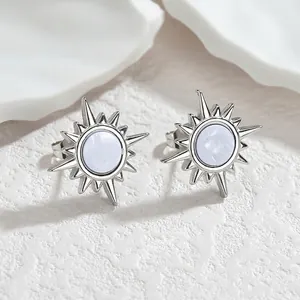 Minimalist stainless steel starburst sun stud earrings with blue center on white stone