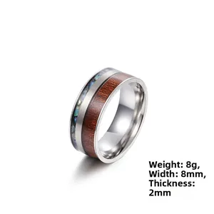 Detailed view of 8mm titanium steel ring featuring wood and abalone shell inlay