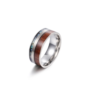 Titanium steel ring with wood and iridescent abalone shell inlay on white background