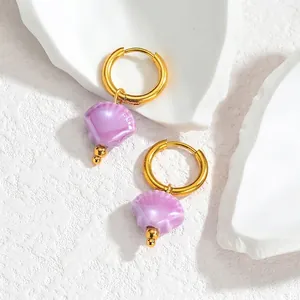 Close-up of S925 sterling silver stamp on golden shell tassel earrings with pearl luster