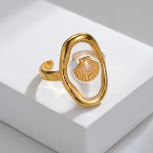 Detailed view of an oval gold-plated ring with shell inlay and adjustable open band
