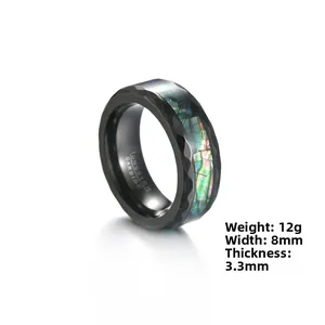 Detail view of 8mm black tungsten carbide ring with faceted edge and abalone shell inlay