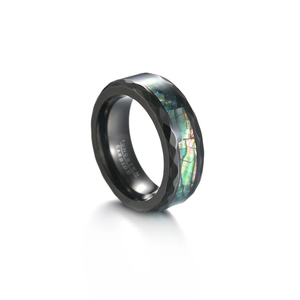 Polished black tungsten ring with faceted edges and colorful abalone shell inlay