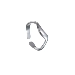 Macro shot of polished silver wave-shaped open ring with minimalist adjustable design