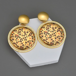 Detail of round leopard print earrings with gold plating and sparkling crystal border