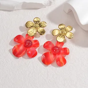 Détails de boucles d'oreilles double fleur en métal martelé doré et résine rouge