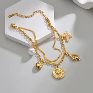 Double-layered gold stainless steel bracelet with butterfly, evil eye, and pearl charms