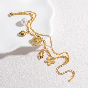Double-layered stainless steel bracelet with gold charms including pearls and butterflies
