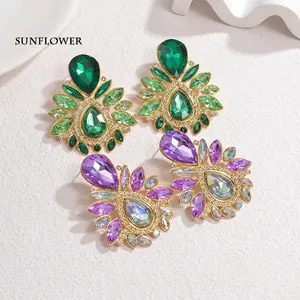 Elegant vintage drop earrings with green and purple crystals in a floral design