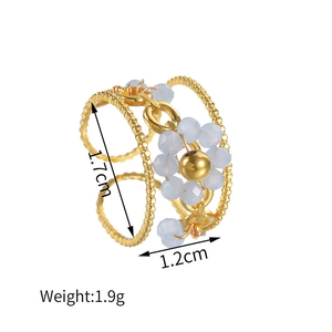 Detail view of gold beaded spiral ring with a blue crystal flower and dimensions