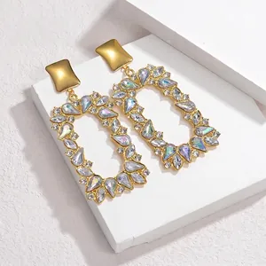 Detailed macro of vintage geometric gold earrings with rainbow crystal rhinestones