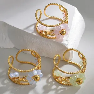 Three-color floral hollow beaded stainless steel open ring set on white marble stone