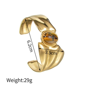 Detailed view of vintage gold cuff bracelet dimensions with inlaid tiger eye stone inlay