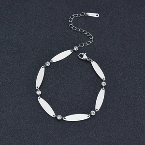 Detailed macro view of silver stainless steel bracelet with oval links and zircon accents