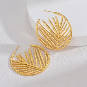 Macro view of 18K gold-plated stainless steel leaf hoop earring with hollow vein patterns