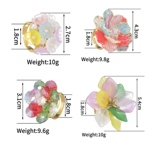 Colorful floral statement rings with gold adjustable bands in four vibrant styles