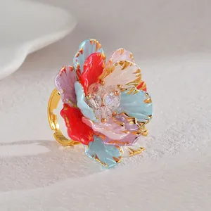 Macro detail of colorful flower ring with crystal core and golden petal edges