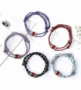 Detail of woven couple bracelets with magnetic heart clasps in five different colors