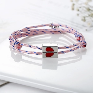 Magnetic matching heart charm braided bracelets for couples with pink and blue cord