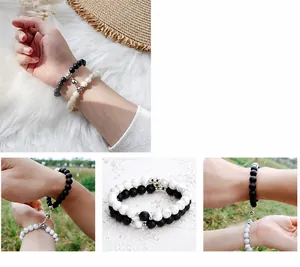 Close-up of magnetic heart-shaped charms on black and white stone bead bracelets