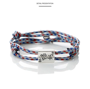 Close-up of woven rope bracelet with engraved magnetic metal buckle showing 89 and 10 numbers