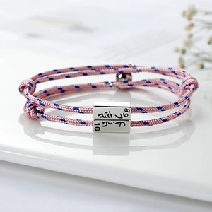 Handwoven pink and blue couple bracelets with magnetic silver charms and numbers
