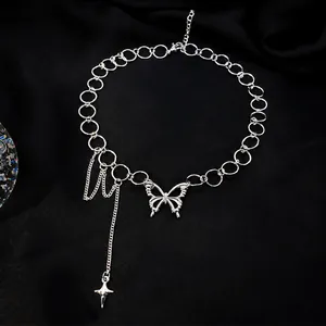 Detail of silver butterfly pendant necklace with ring links and star tassel on silk