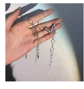 Detail of silver butterfly pendant with multi-layered chains and ring connectors