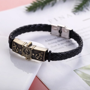 Detail of nautical braided leather bracelet with bronze anchor and stainless steel clasp