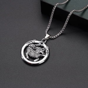 Macro view of a silver Kirin pendant on a steel box chain with vintage details