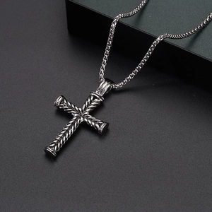 Detailed macro shot of vintage stainless steel cross pendant with rope texture and bead chain