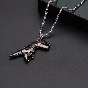 Detail of grey dinosaur skull pendant with red star eye and carved DINOSAUR text