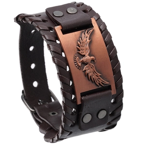 Detailed macro view of retro brown leather bracelet with an eagle metal embossed plate